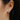 Close-up of a clover-shaped earring.